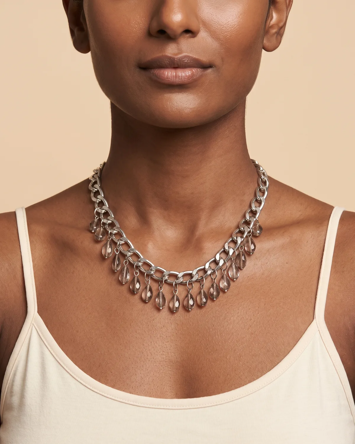 Chandelier Chain: a silver curb chain fringe design, adorned with a row of dangling, smoky translucent teardrop-shaped crystal beads.