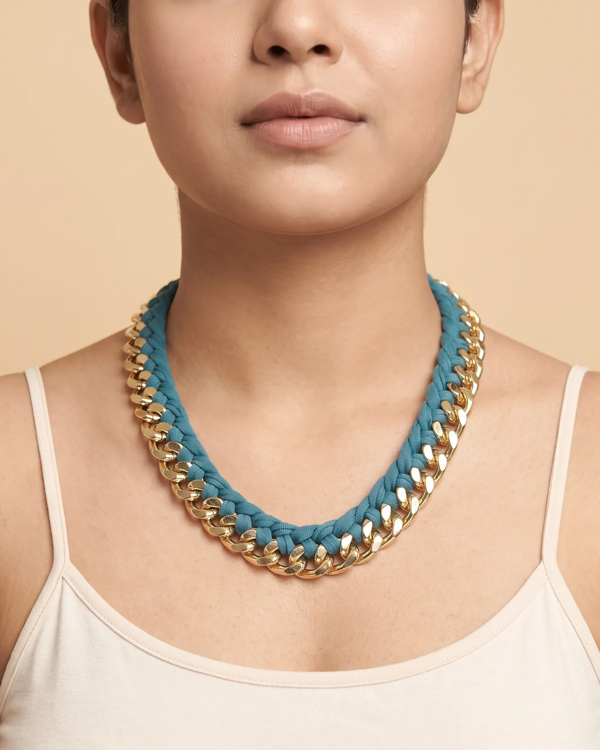 Deep Sea Interlace Choker: a chunky, polished gold curb chain intricately interwoven with a thick, textured teal-blue fabric cord.