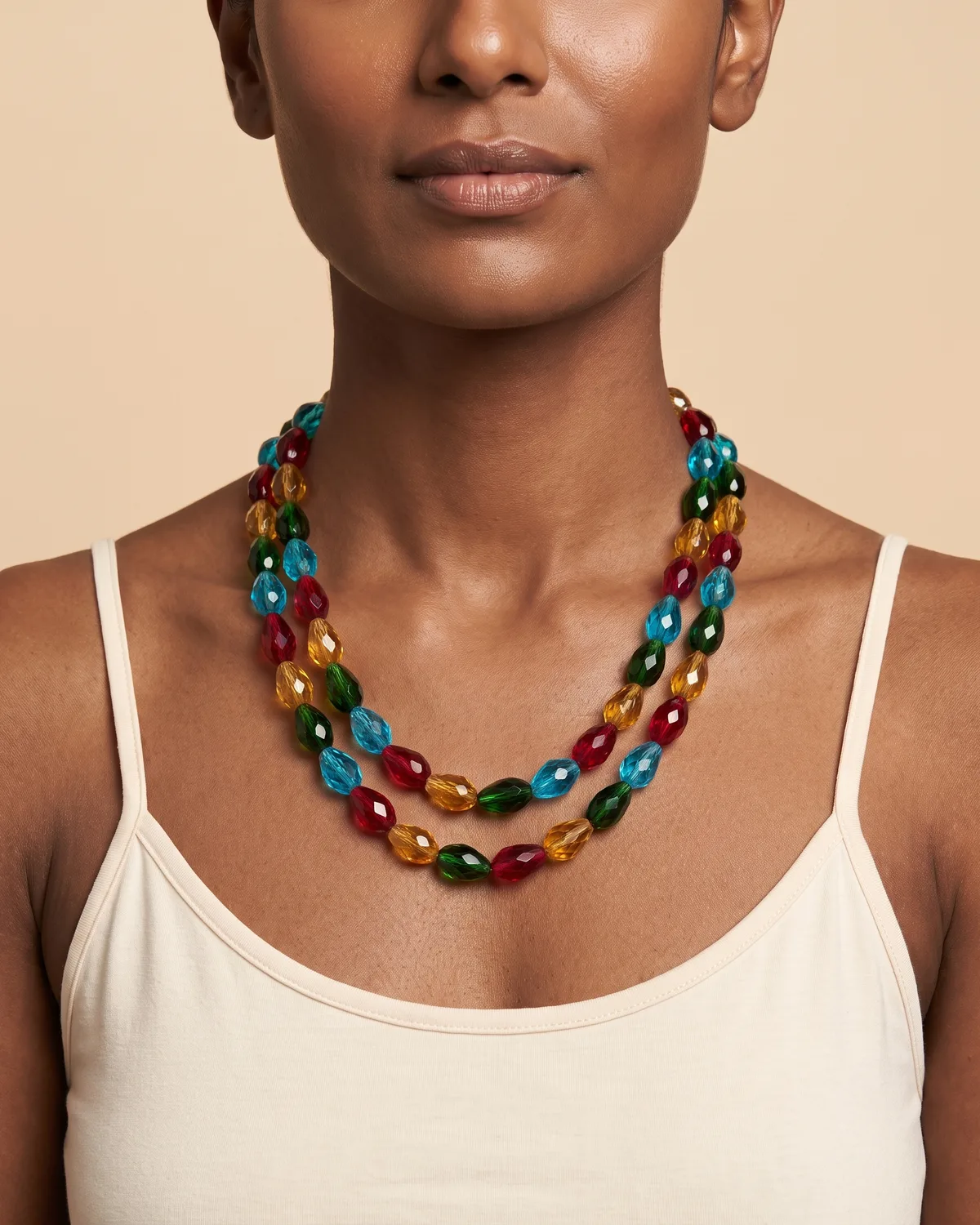 Prism Dance Layer: a double strand of faceted, teardrop-shaped crystal beads in a festive palette of red, blue, green, and golden yellow.
